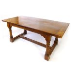 A burr oak refectory style dining table, the two plank top with cleated ends, on a base with ring