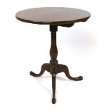 A 19th century mahogany circular occasional table on baluster column and out swept tripod base.