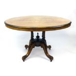 A Victorian walnut tilt top breakfast table, quarter veneered top raised on four column support with