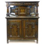 A late 17th century and later inlaid oak press cupboard with a canted three panelled upper section