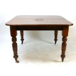 A late Victorian mahogany wind out dining table, rounded rectangular top, raised on turned legs with