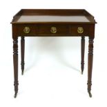 An Edwardian mahogany writing table, with three quarter gallery, two frieze drawers flanking a dummy
