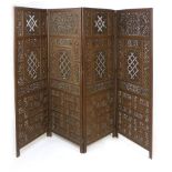 An eastern hardwood four fold screen, panels pierced with foliate, bird and geometric designs,