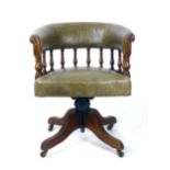 A Victorian mahogany and leather upholstered tub desk chair, circa. 1890, with turned baluster