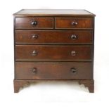 An oak and mahogany cross-banded chest of drawers, early 19th century, with a feather banded top,