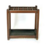 A mahogany stick stand, late 19th century, with twelve divisions and wrought iron drip tray, h. 71