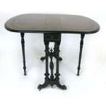 A Victorian amboyna, ebony and boxwood inlaid Sutherland table, in the Aesthetic style, raised on