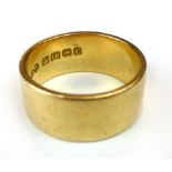 An 18 ct gold wedding band, total weight 12 gms approximately. CONDITION REPORT: Wear marks.  w.