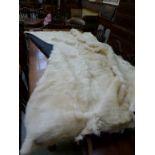 A large goat skin bed spread or blanket, black silk backing 230 cm x 210 cm approximately. CONDITION
