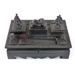 An Anglo Indian ebony partners desk stand, with various lidded compartments and pen trays and a