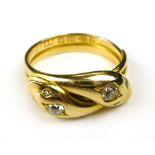 An 18 ct gold ring in the form of two en