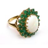A large opal and emerald cluster ring on