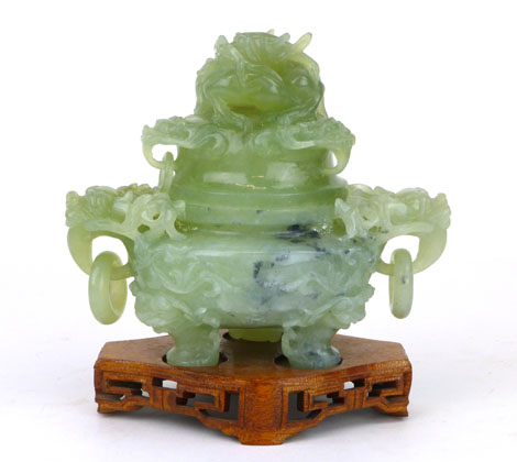 A Chinese green jade type censor and cover, with carved dragon finial, hoop handles on a pierced
