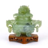 A Chinese green jade type censor and cover, with carved dragon finial, hoop handles on a pierced