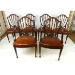 A set of eight Hepplewhite style dining chairs, shield shaped back, leather upholstered serpentine