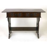 An Arts and Crafts oak hall table, with twin frieze drawers raised on heart pierced supports.  w.