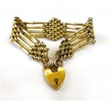 A 9 ct gold fancy link bracelet with hea