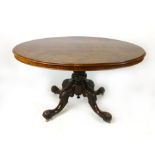 A Victorian walnut oval tilt top breakfast table, mid 19th century, on a turned and carved