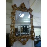 A Chippendale style wall mirror, probably early 20th century, with a Rococo scrolling foliate