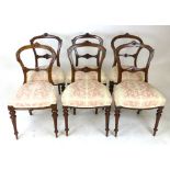 A matched set of six hoop back walnut saloon/dining chairs, late 19th century, with carved