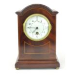 An Edwardian mahogany and boxwood inlaid mantle clock, the 3 1/2" white and floral enamelled dial on