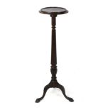 A mahogany jardiniere stand, first half of 20th century, circular tray top on a reeded column and