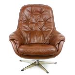 A 1970's brown leather tub-style armchair on an aluminium five-star base CONDITION REPORT: No