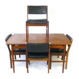 A 1960's teak extending dining table, l. 140.9 cm, together with four matching chairs with black