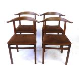 A set of four 1950's teak dining chairs with wishbone-shaped back-rests, retailed by Heals CONDITION