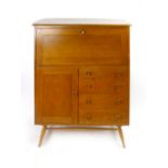 An Ercol elm cabinet, the fall front over a door and four drawers on circular tapering beech legs,