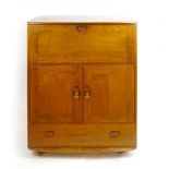 An Ercol elm bureau, the fall front over two doors and a drawer, on castors, w. 83 cm CONDITION