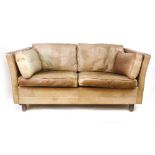 A Danish brown leather two-seater sofa on mahogany straight legs, in the manner of Borge Mogensen,