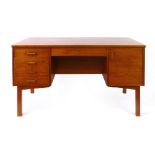 A 1960/70's teak desk with an arrangement of five drawers and one door on square tapering legs, l.