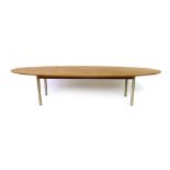 John and Sylvia Reid for Stag, a teak oval coffee table on spun aluminium cylindrical legs, l. 151