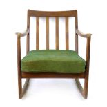 A 1960's teak framed rocking chair of organic form, in the manner of Ole Wanscher CONDITION