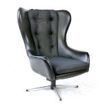 A 1960's black vinyl wingback armchair with chrome four-star swivel base   CONDITION REPORT: Seat