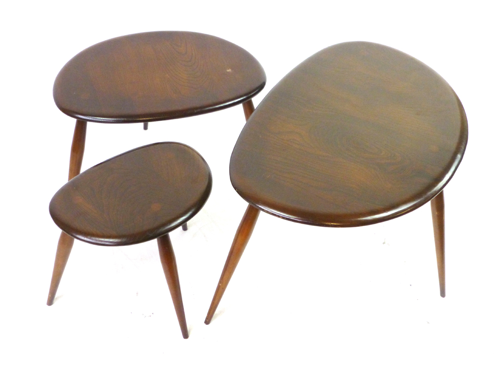 A nest of three Ercol pebble coffee tables in stained ash and beech, max l. 65 cm CONDITION