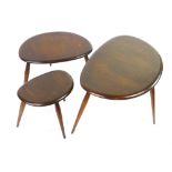 A nest of three Ercol pebble coffee tables in stained ash and beech, max l. 65 cm CONDITION