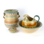 A four piece dressing table set decorated with a pale orange, green and blue glazes by Shorter & Son