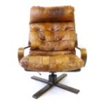 A 1960/70's bentwood and tan leather lounge armchair on a four-star base CONDITION REPORT: One