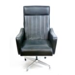 A 1970's black vinyl highback armchair on a chrome five-star swivel base with castors CONDITION