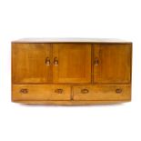 An Ercol elm sideboard, the three doors above two drawers on castors, l. 130 cm CONDITION REPORT: