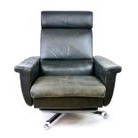 A 1970's black leather highback reclining armchair on a chromed five-star swivel base CONDITION