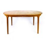 A McIntosh teak extending dining table of cushioned form on beech oval tapering legs, max l. 204