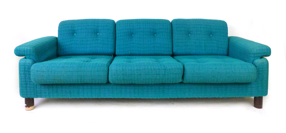 A 1970's low three-seater sofa with blue and turquoise upholstery on mahogany circular legs, l.