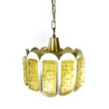 A 1970's aluminium and brass coloured ceiling light, the twelve segments with yellow moulded glass