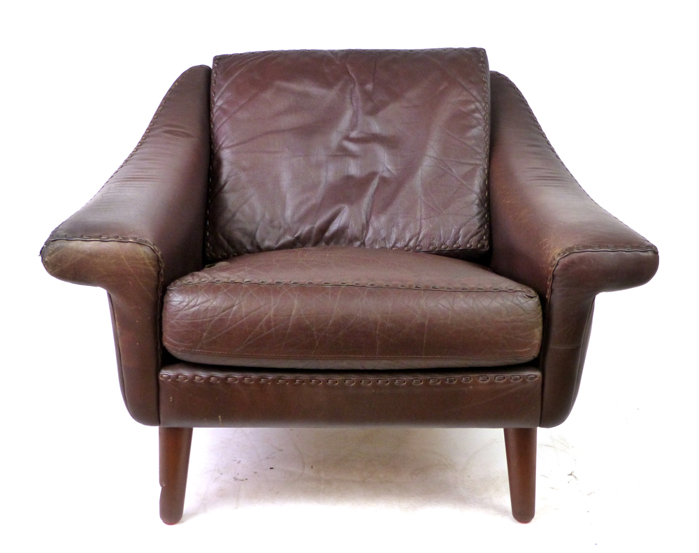 A Danish brown leather armchair on mahogany turned legs by Eran CONDITION REPORT: Structurally sound