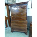 A George III mahogany chest on chest, early 19th Century, with blind fretwork frieze, two short