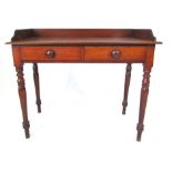 A Victorian mahogany side table with three quarter gallery above two false drawers with turned