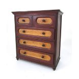 A mahogany and maple miniature chest of two short and three graduated long drawers with turned pulls